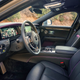 The interior of the 2023 Rolls-Royce Black Badge Ghost interior in black, purple and carbon